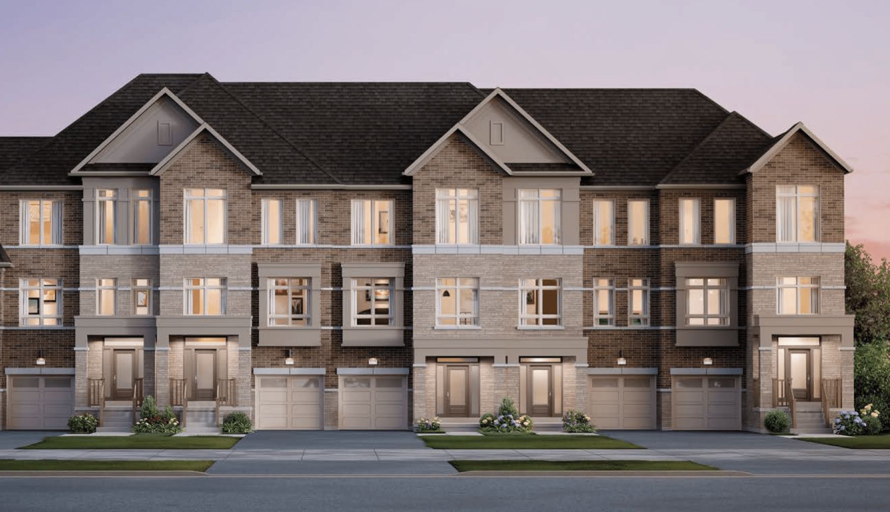 Rendering of a row of brick freehold townhomes at dusk