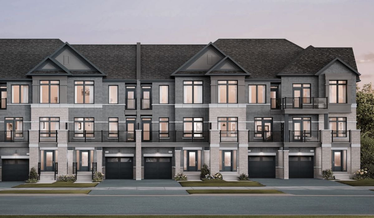 The Laurel, grey brick townhomes with balconies